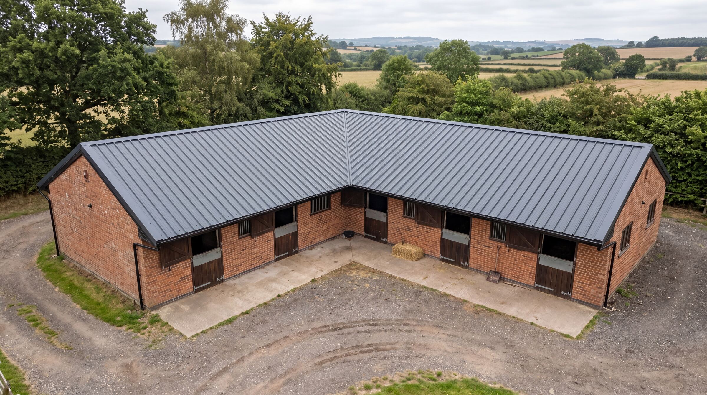 UK stable block with anthracite Mighty Structural box-profile metal roofing sheets