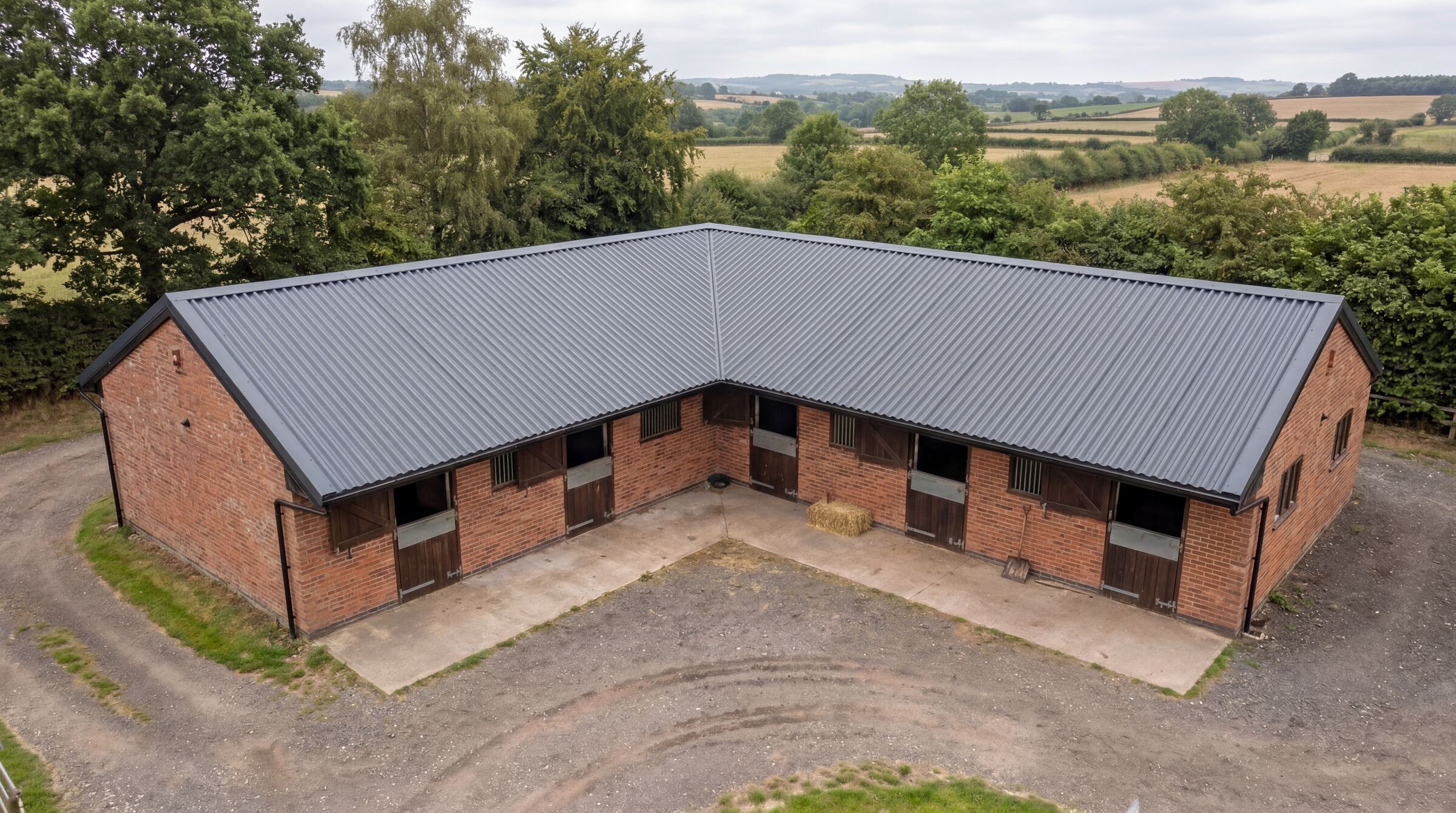 UK stable block with anthracite Mighty Structural corrugated metal roofing sheets