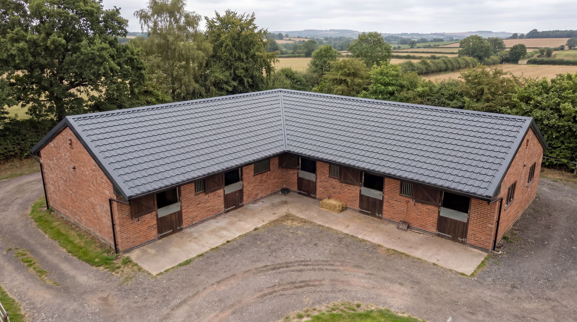 UK stable block with anthracite Mighty Structural tile-effect metal roofing sheets
